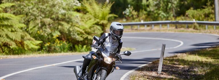 Rider on curve in bush setting 